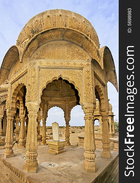Very richly decorated sculpted and carved in yellow sandstone this cenotaph is constructed with pillars, arches and dome in Mogul style in memoriam of ancient rulers of the rich city of Jaisalmer, Rajasthan, India. Very richly decorated sculpted and carved in yellow sandstone this cenotaph is constructed with pillars, arches and dome in Mogul style in memoriam of ancient rulers of the rich city of Jaisalmer, Rajasthan, India.