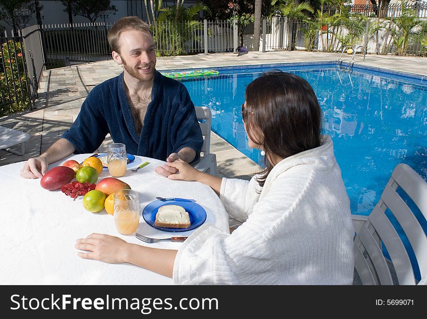 Couple Sitting at Table Holding Hands - horizontal