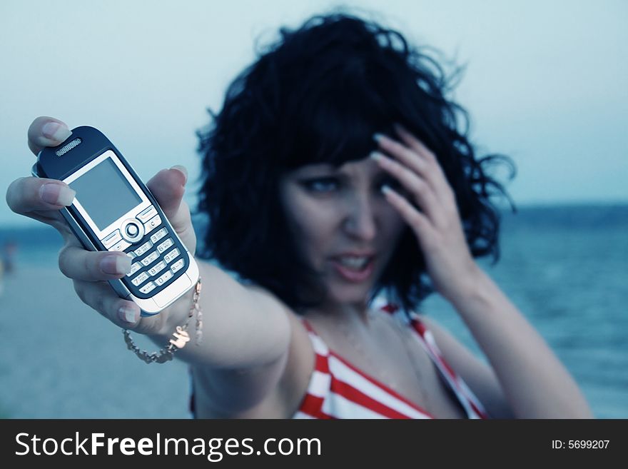 Young girl holding a mobile phone. Young girl holding a mobile phone