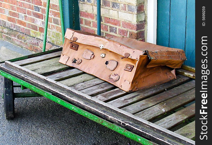 Unacceptable for travel damaged suitcase on rail station trolley
