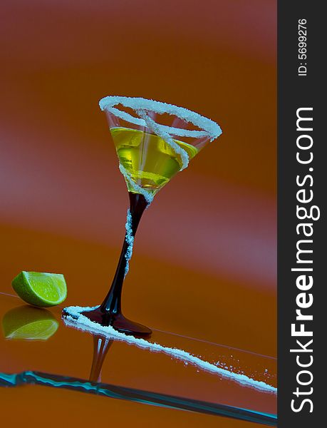 View of nice colorful martini glass with some piece of lime