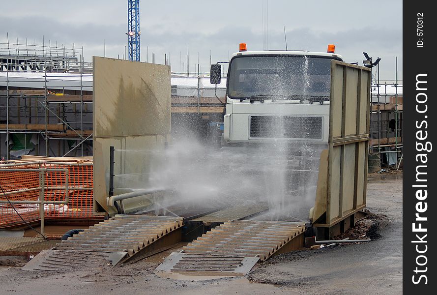 Truck entering a chassis wash on a construction site. Truck entering a chassis wash on a construction site