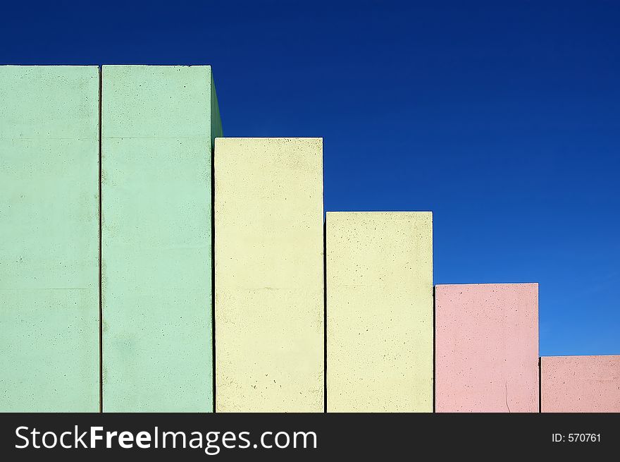 Concrete stairs shaped as chart on blue sky background colored from red to green. Concrete stairs shaped as chart on blue sky background colored from red to green