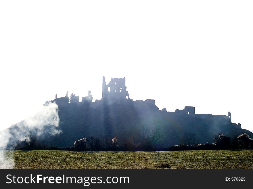 Ruins of Corfe Castle, in Swanage, Dorset, Southern England as seen from the steam train running alongside.