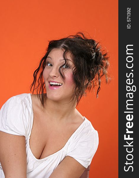 Girl with up-do in Front of orange Background - laughing. Girl with up-do in Front of orange Background - laughing