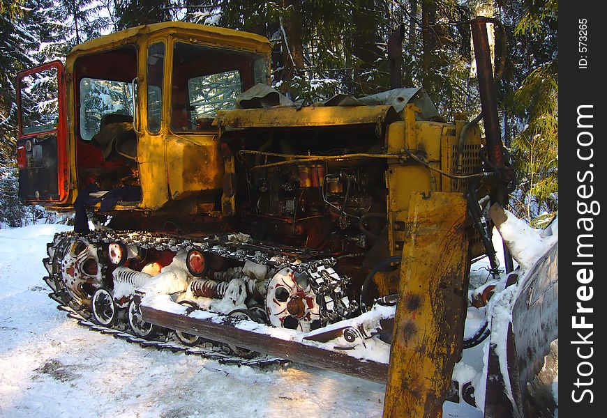 Old rusted catterpillar broken in the forest. Old rusted catterpillar broken in the forest