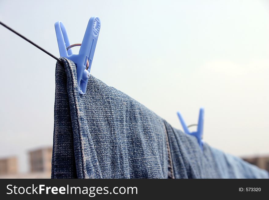 Clothesline with two pairs of jeans hanging. Clothesline with two pairs of jeans hanging