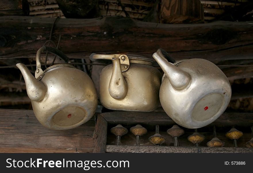Old metal teapots hanging at an antique market. Old metal teapots hanging at an antique market