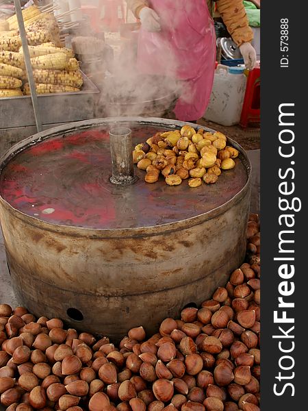 Roasted walnuts with a person in the background