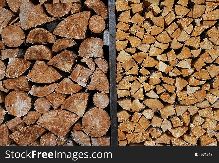 Two stacks of split firewood in different size. Two stacks of split firewood in different size