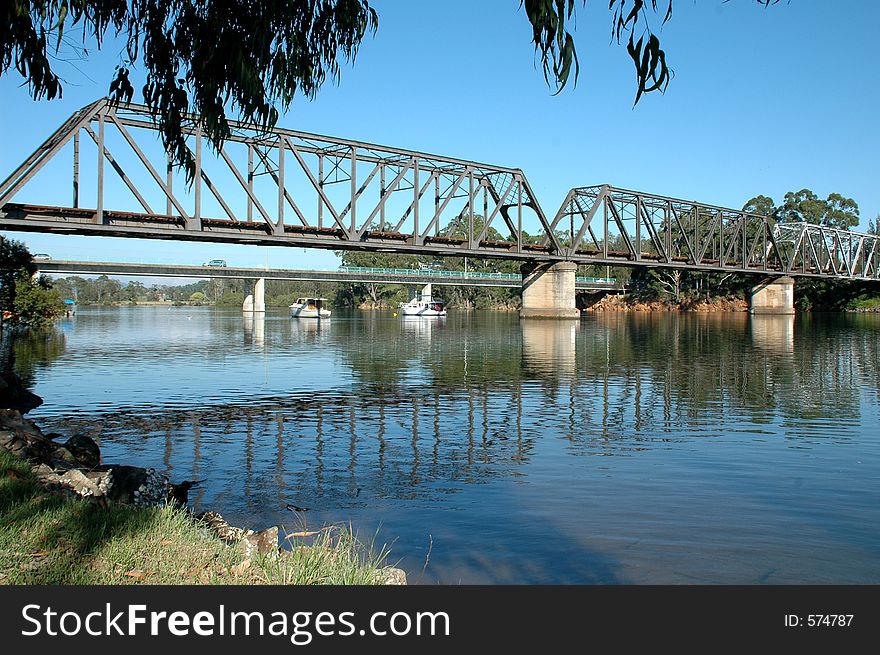 View of boats moored under the bridge