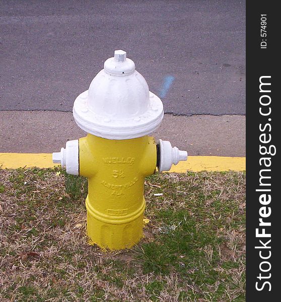 Yellow and white city fire hydrant. Yellow and white city fire hydrant.