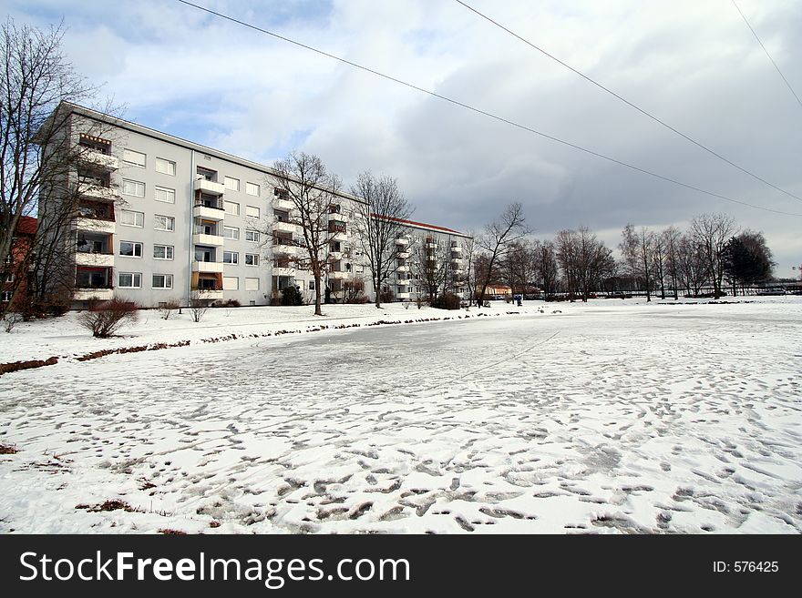 Residential area in Winter.A frozen lagoon in frongt of apartments. Residential area in Winter.A frozen lagoon in frongt of apartments.