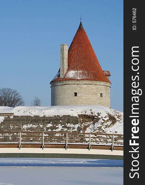 A view from a frozen lake to an old castle tower in Estonia (Saaremaa). A view from a frozen lake to an old castle tower in Estonia (Saaremaa)