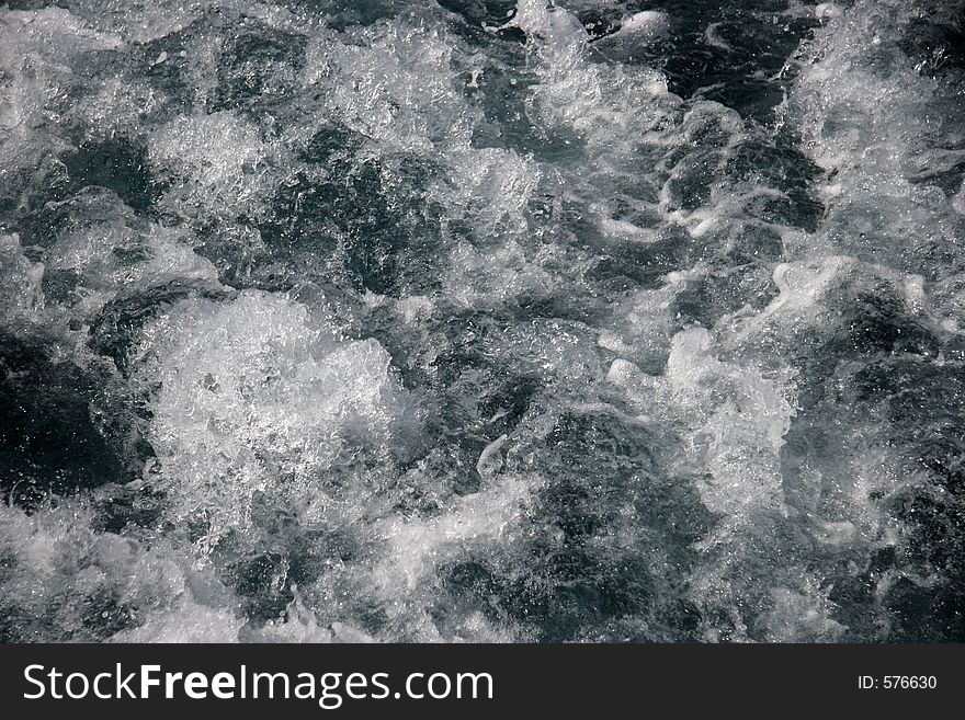 Burling water behind the yacht's motors.