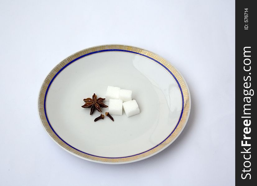 A partially filled plate with spice and sugar - Isolated. A partially filled plate with spice and sugar - Isolated