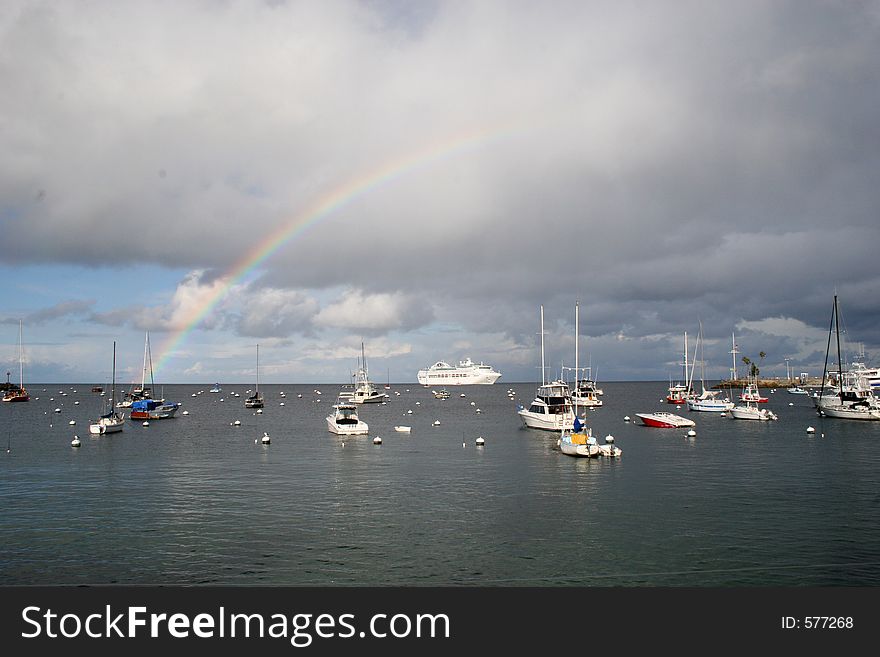 Sailboats at sea, under a rainbow, after the rain. Sailboats at sea, under a rainbow, after the rain