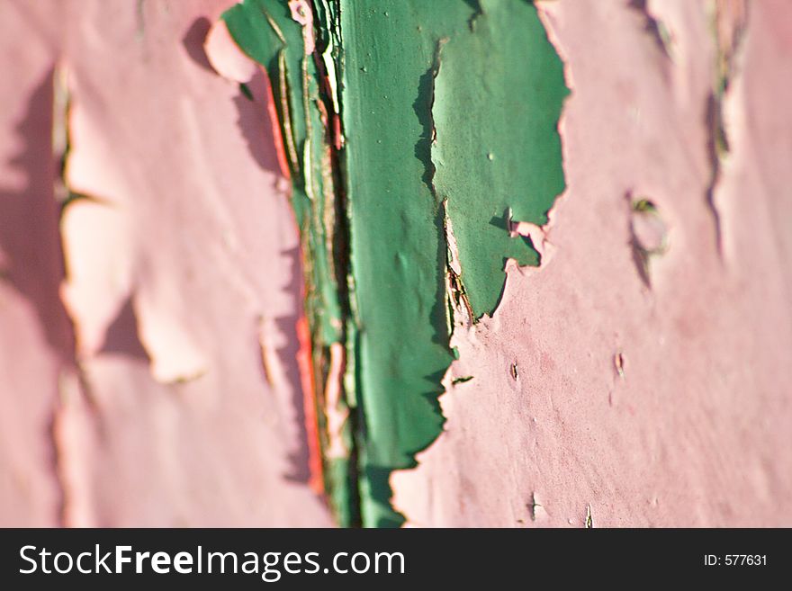 Old green paint showing through flaking pink layer. Old green paint showing through flaking pink layer