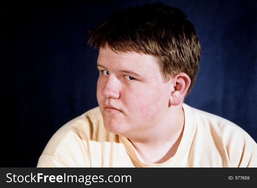 Portrait of a teenage boy glancing suspiciously to the side. Portrait of a teenage boy glancing suspiciously to the side.