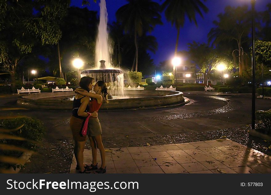 Mother and daughter sharing a special moment in the evening at the town-square. Mother and daughter sharing a special moment in the evening at the town-square