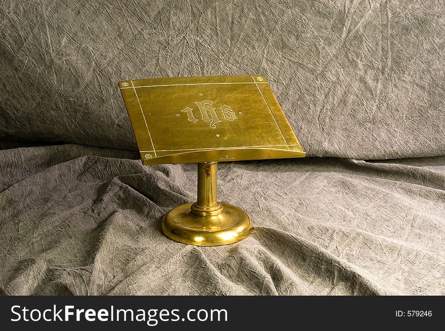 A brass Bible stand used on the alter to hold the Gospel