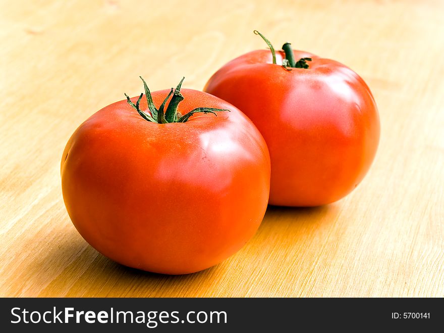 Two tomatoes  .a close up shot.