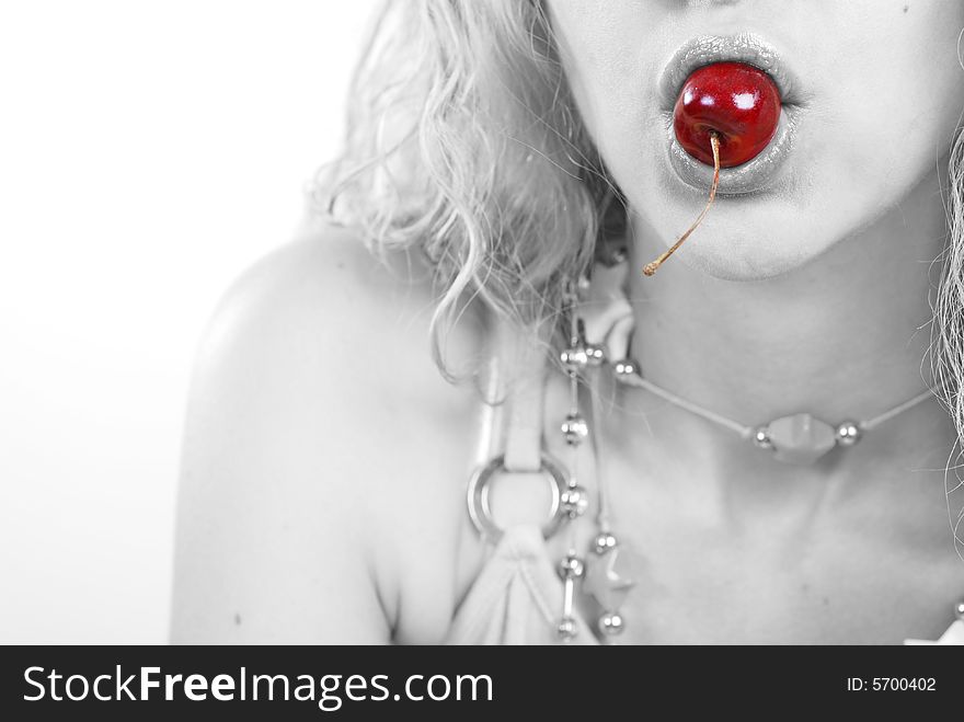 Beauty young woman with red cherry in mouth