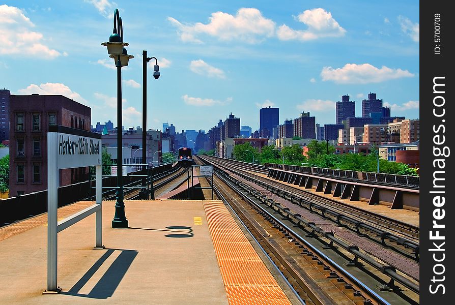 Commuter train approaching E. 125th Street station in New York.