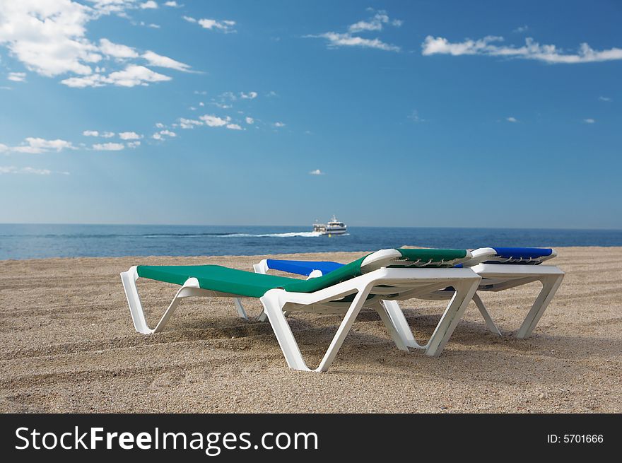 A photo of two chairs on the beach