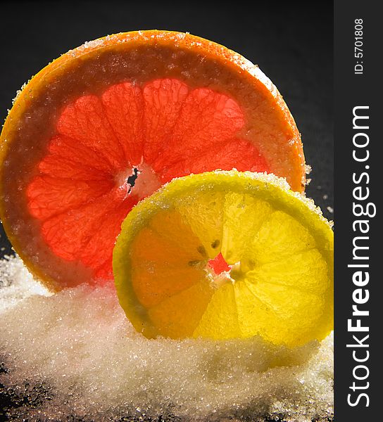 Lemon and the grapefruit strewed by sugar. Lemon and the grapefruit strewed by sugar