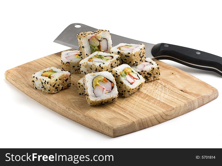 Sushi slices on a wooden board on white background. Sushi slices on a wooden board on white background