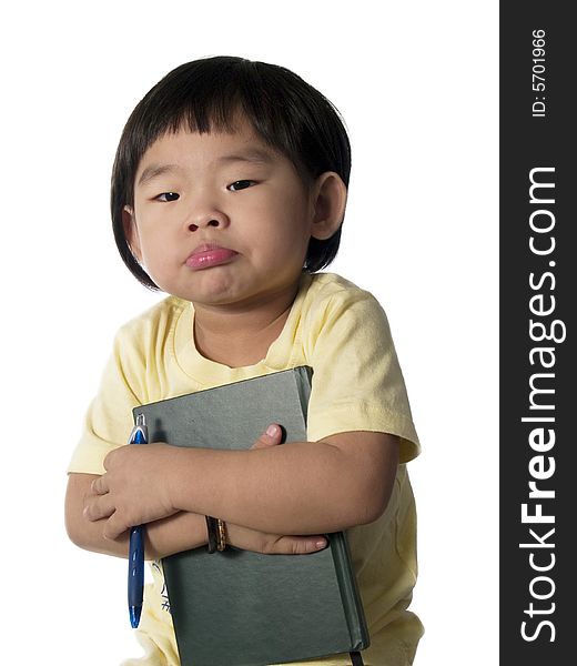 Little Chinese girl holding note book and pen. Little Chinese girl holding note book and pen