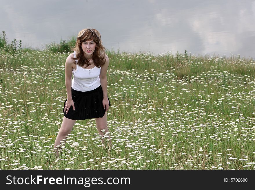 A beautiful girl walking near the lake. A beautiful girl walking near the lake