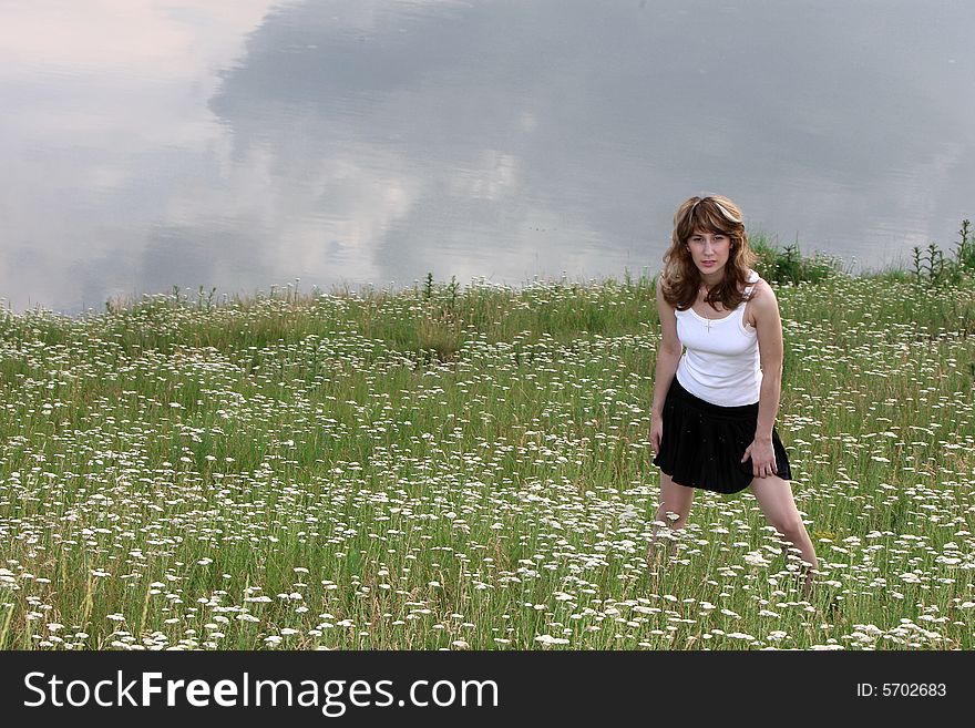 A beautiful girl walking near the lake. A beautiful girl walking near the lake