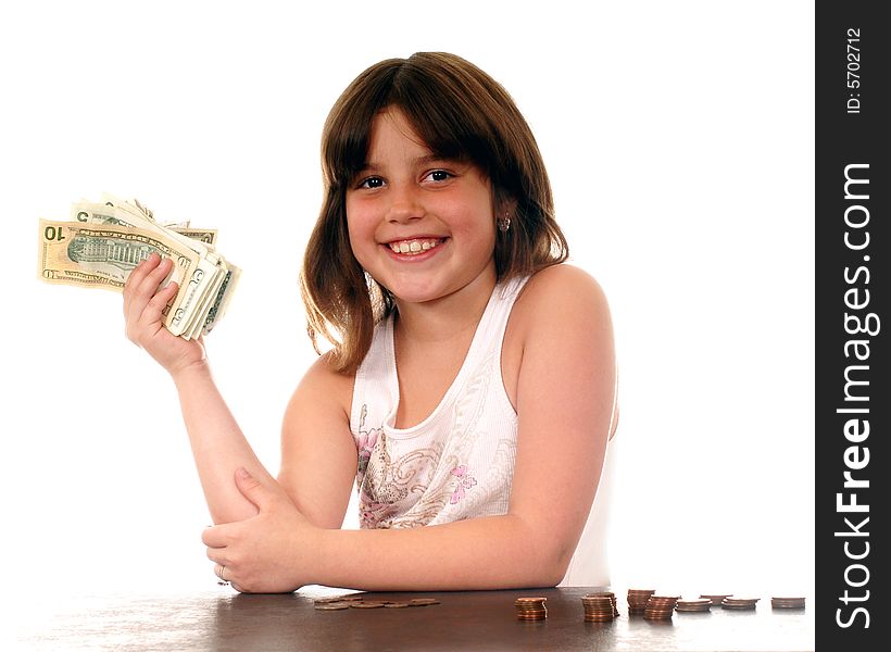 Elementary girl delighted with the fist full of dollars she's holding. Elementary girl delighted with the fist full of dollars she's holding.