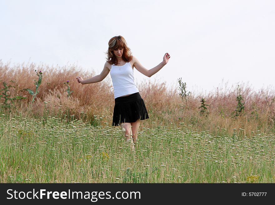 A beautiful girl walking on the field