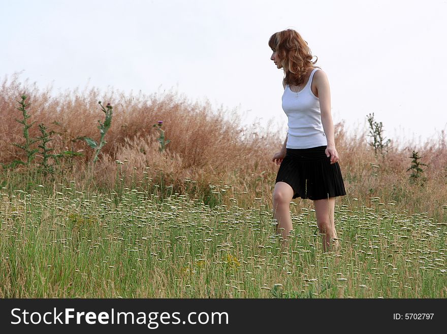 A beautiful girl walking on the field