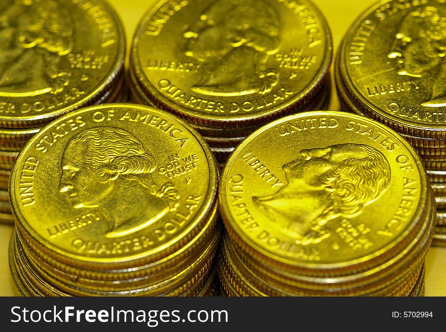 Piles of US golden quarter dollar