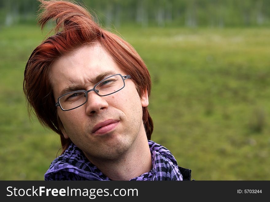 Young man with glasses looking sceptical