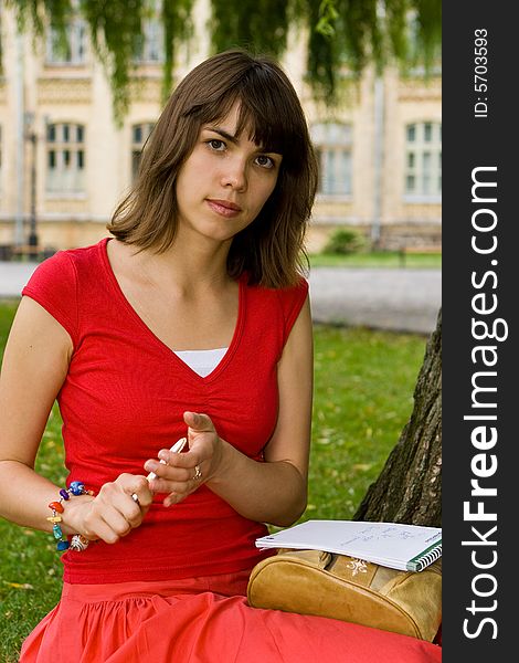 A beautiful young college girl sitting outside. A beautiful young college girl sitting outside