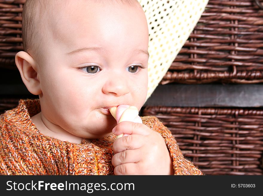 Six month old baby sitting infront of wooden drawers. Six month old baby sitting infront of wooden drawers