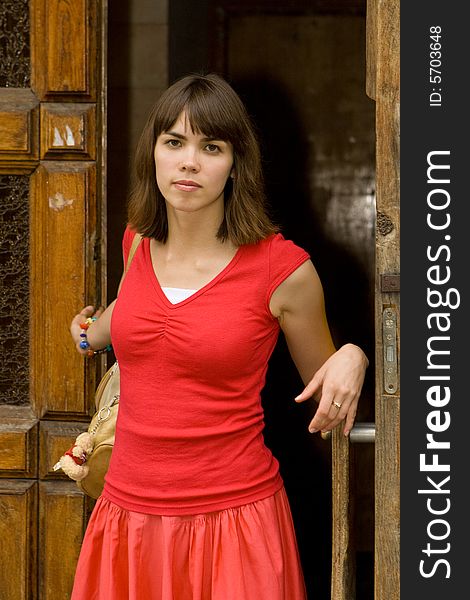 A beautiful young college girl posing by a door. A beautiful young college girl posing by a door