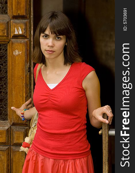 A beautiful young college girl posing by a door. A beautiful young college girl posing by a door