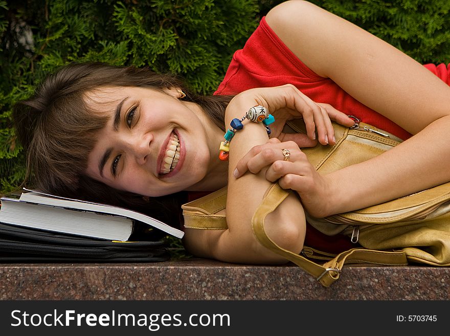 A beautiful young college girl resting on a marble plate. A beautiful young college girl resting on a marble plate