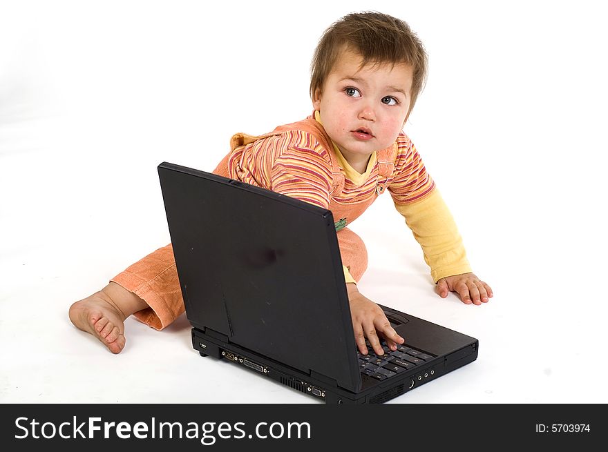 Orange dressed boy working on laptop