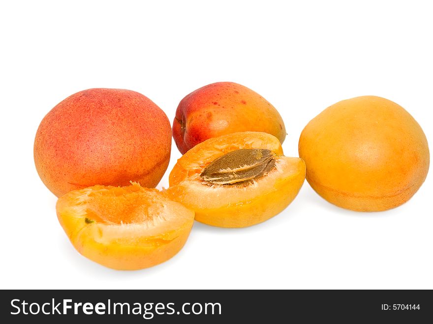 Three whole apricots and one apricot is broken