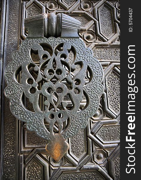 Door handle and ornament background (Cathedral in Seville, Spain)