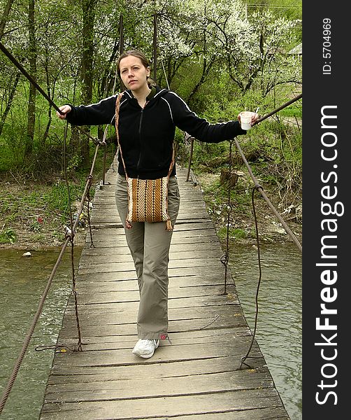 Young girl on a foot bridge in Maramures county of Romania.