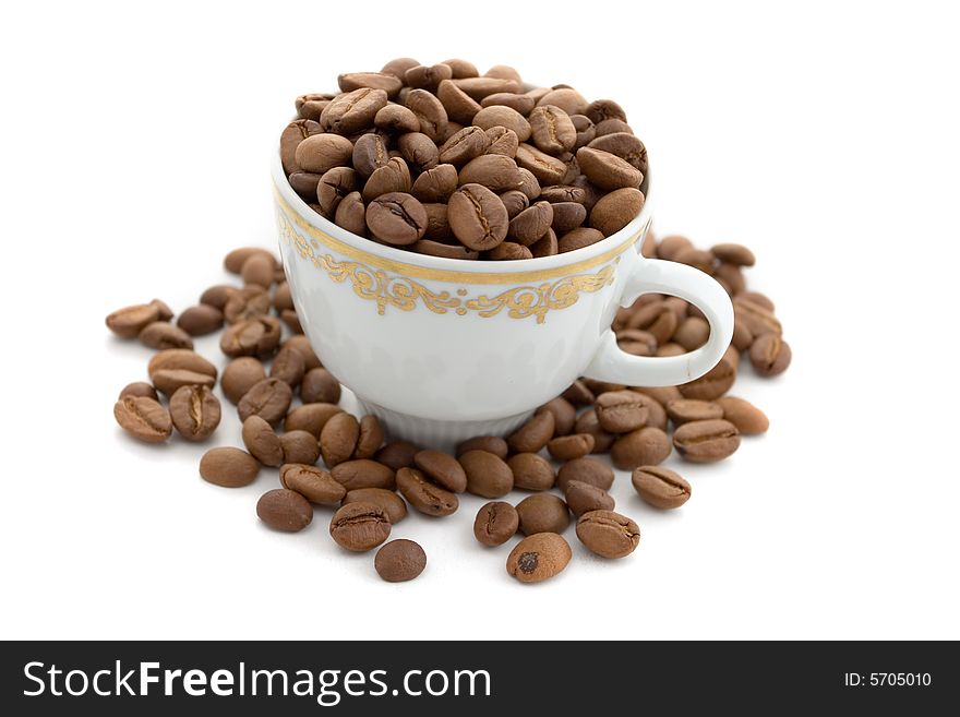 Coffee beans in the cup on a white background. Coffee beans in the cup on a white background
