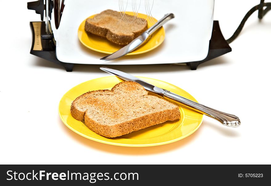 Toaster, plate are retro. Reflection of plate of toast and knife in chrome toaster. Toaster, plate are retro. Reflection of plate of toast and knife in chrome toaster.